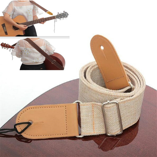 Beige cotton-linen guitar shoulder strap with tan leather ends and metal buckle