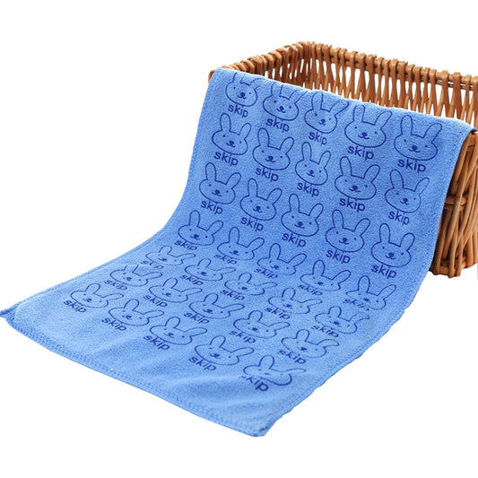 Dark blue kids microfiber towel with cute bunny pattern, folded for use