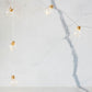 Copper wire LED string lights with warm clear mini globe bulbs on cord, close-up