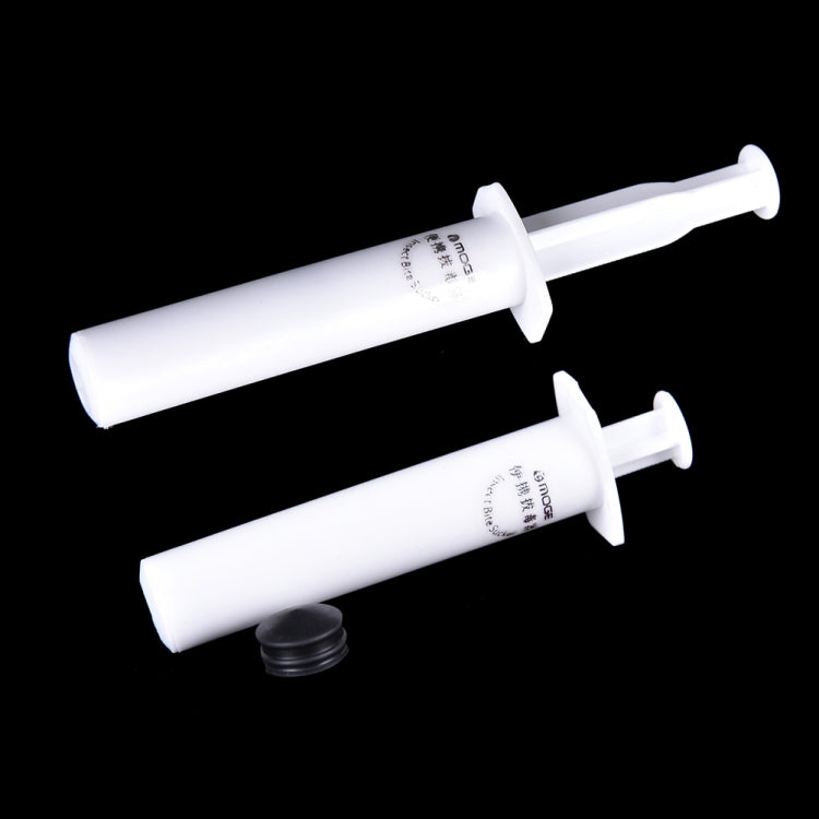 Two white venom extractor suction syringes with flanged tips for emergency use