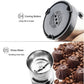 Stainless electric grinder with vented underside and inner blade cup, shown with coffee beans