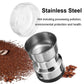 Stainless electric coffee grinder with open clear lid and visible coffee grounds in cup