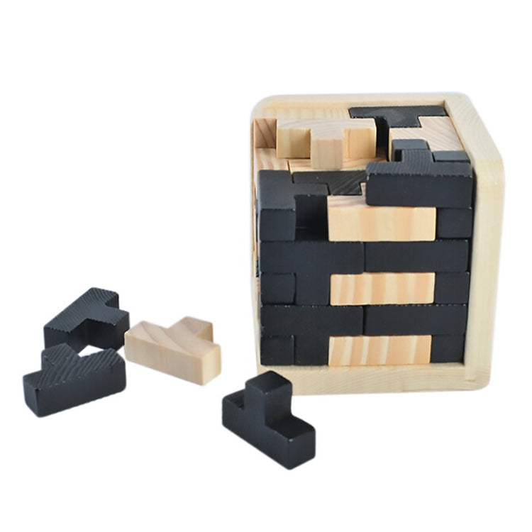 Wooden interlocking puzzle cube with scattered black block pieces and light wood blocks