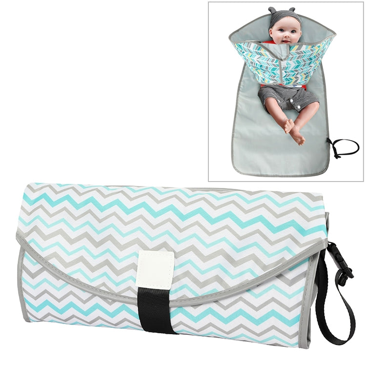 Portable folding waterproof changing pad, teal zigzag pattern with gray sides and carry strap.