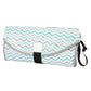 Folding waterproof changing pad with teal zigzag pattern, gray edge trim, and black carry strap.