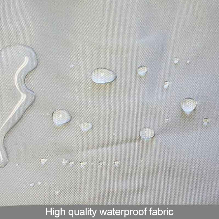 Waterproof changing pad fabric surface with visible water droplets on light gray material.