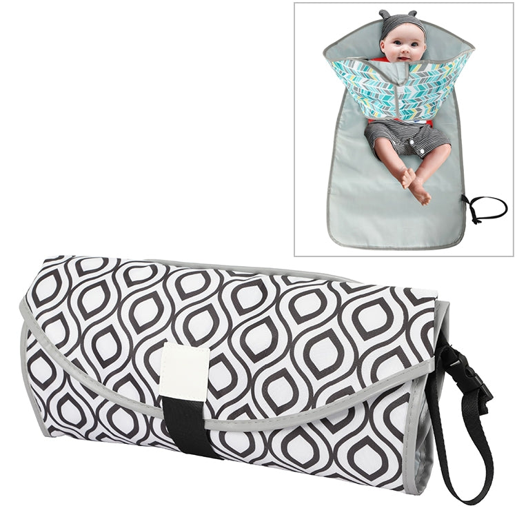 Folding waterproof changing pad, black and white geometric pattern with carry strap.