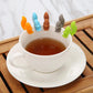 Silicone squirrel cup charms set, orange, blue, brown, gray, and green on teacup