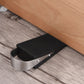 Door anti-theft pad installed on floor: black ridged block with metal band