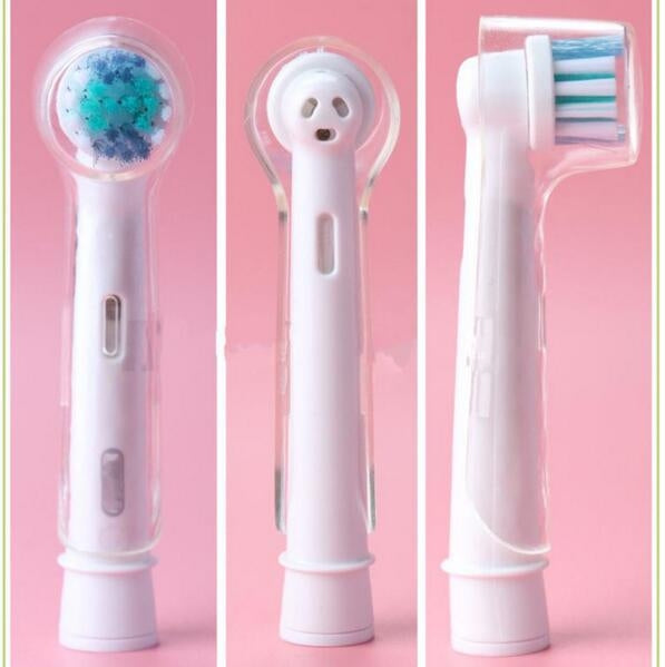 Clear protective covers over electric toothbrush heads, bristle area visible through cap