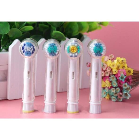Clear covers on electric toothbrush heads, with colored bristles visible through