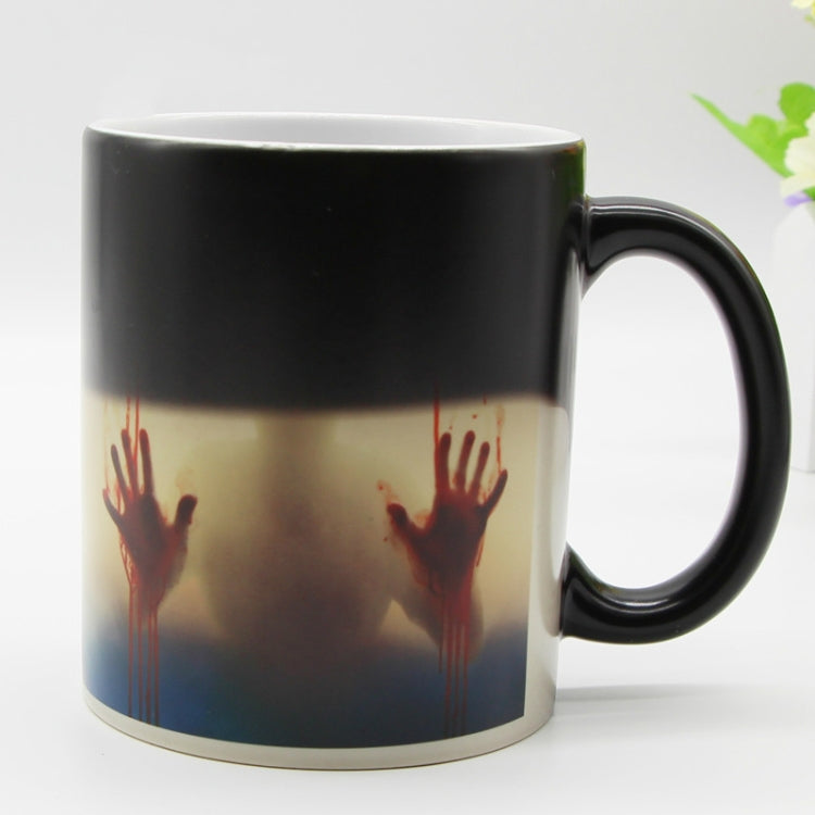 Color-changing ceramic coffee mug with red handprint graphic and black top band, black handle