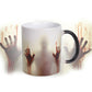 Color-changing ceramic coffee mug with red handprint graphic, pale center, black handle
