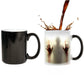 Two color-changing ceramic coffee mugs with red handprint graphic, black and white views