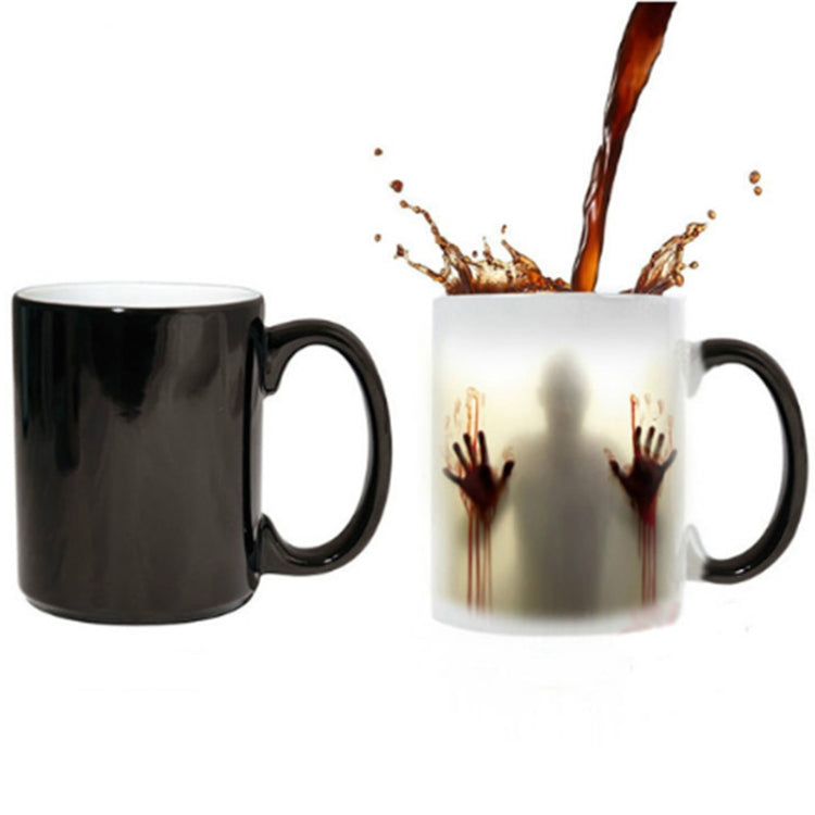 Two color-changing ceramic coffee mugs with red handprint graphic, black and white views