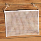 Empty white mesh hanging organizer with suction cups, rectangular pocket.