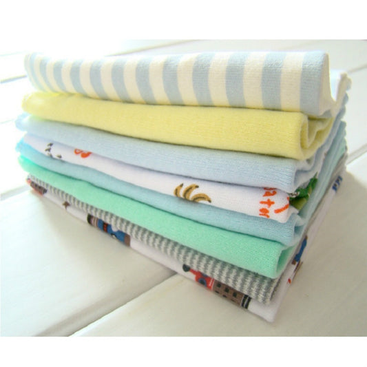 Cotton baby washcloth set, folded light blue, yellow, mint, and patterned towels