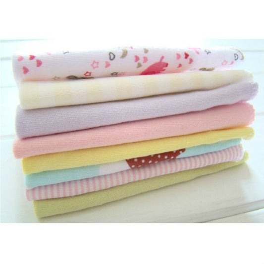 Cotton baby washcloth set, folded pastel towels in pink, yellow, and lavender