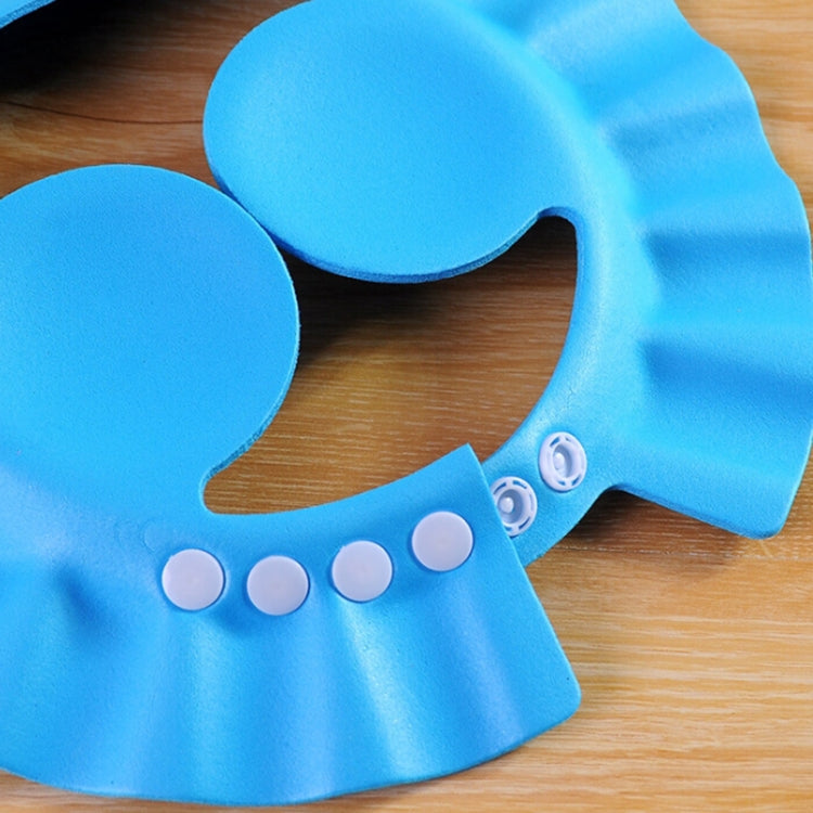 Blue kids shower cap earflap hair shield with scalloped edge and eye dot details