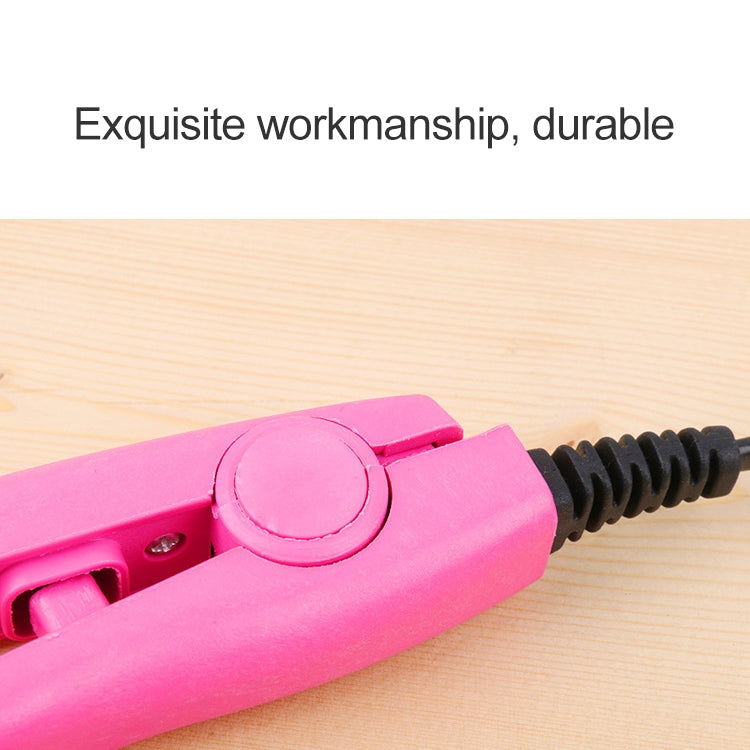 Mini hair straightener with pink control dial and ceramic heating plates