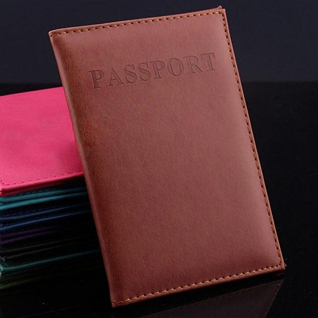 Brown faux leather passport travel cover with embossed PASSPORT title and stitched border