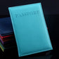 Light blue faux leather passport travel cover with embossed PASSPORT title and stitched edge