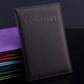 Dark gray faux leather passport travel cover with embossed PASSPORT title and stitched edge