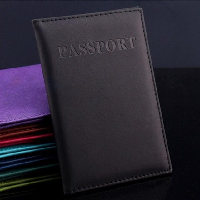 Dark gray faux leather passport travel cover with embossed PASSPORT title and stitched edge