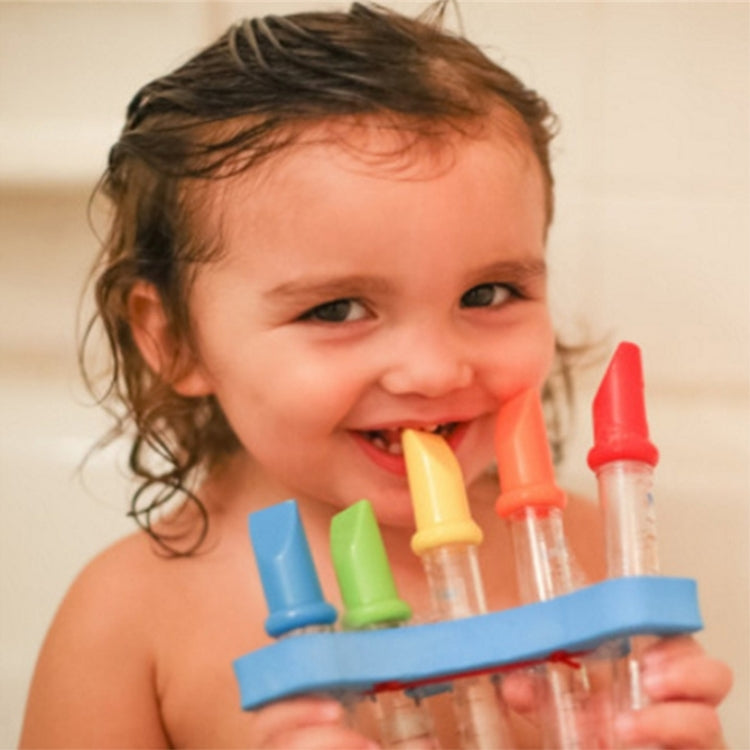 Children’s water flute bath toy with clear tubes and colorful end caps, held in hand