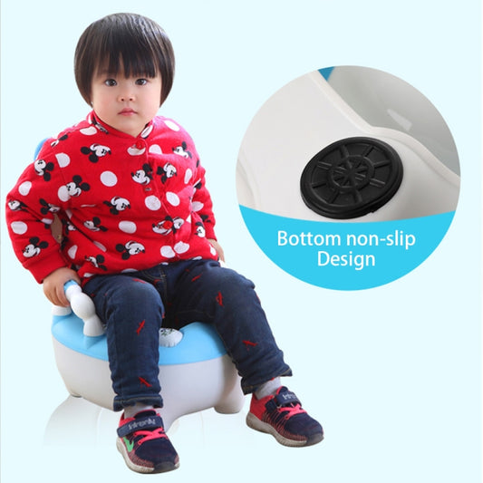 Child seated on white and blue potty training seat with animal character backrest