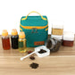 Teal insulated seasoning bag with bottles, spice jars, and small measuring spoon on table.