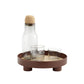 Round glass bottle and cup tray with bottle stopper, brown base and three feet