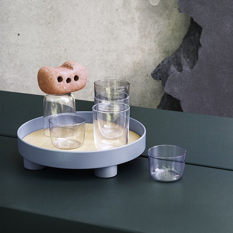 Round tray with beige center and dark feet, holding clear drinking glasses and sponge