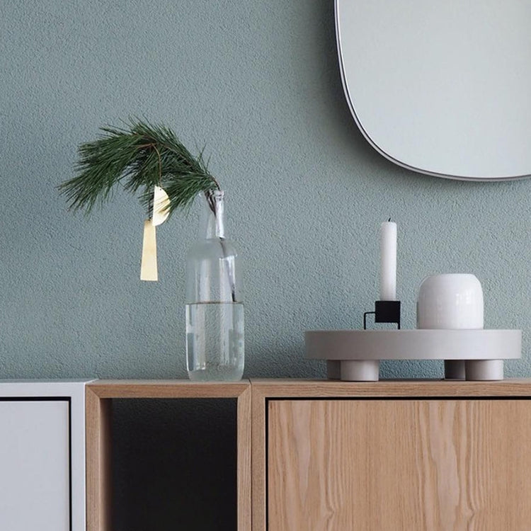 Round desktop tray with dark rim, holding small containers on a shelf