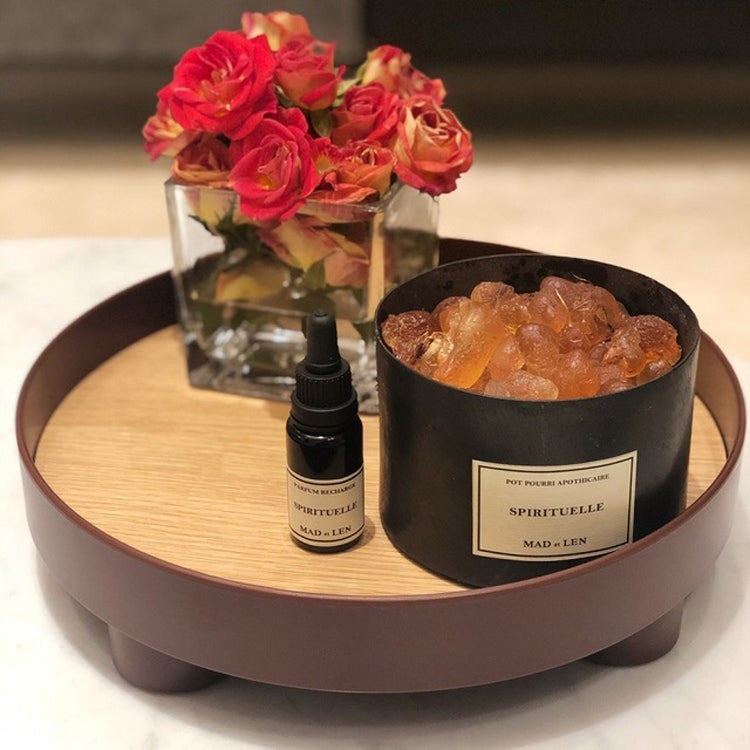 Round storage tray with wood-style insert, brown rim and feet, holds perfume bottles