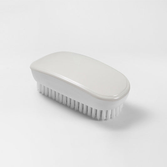 White oval shoe cleaning brush with soft bristles and smooth plastic handle