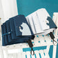 Set of mini pocket folding umbrellas in navy blue and white, each with bear print cover