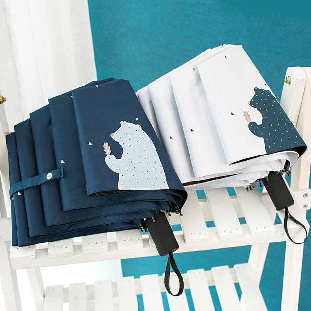 Set of mini pocket folding umbrellas in navy blue and white, each with bear print cover