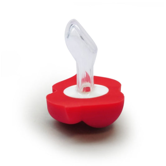 Red silicone lips pacifier with clear nipple shield on a red base