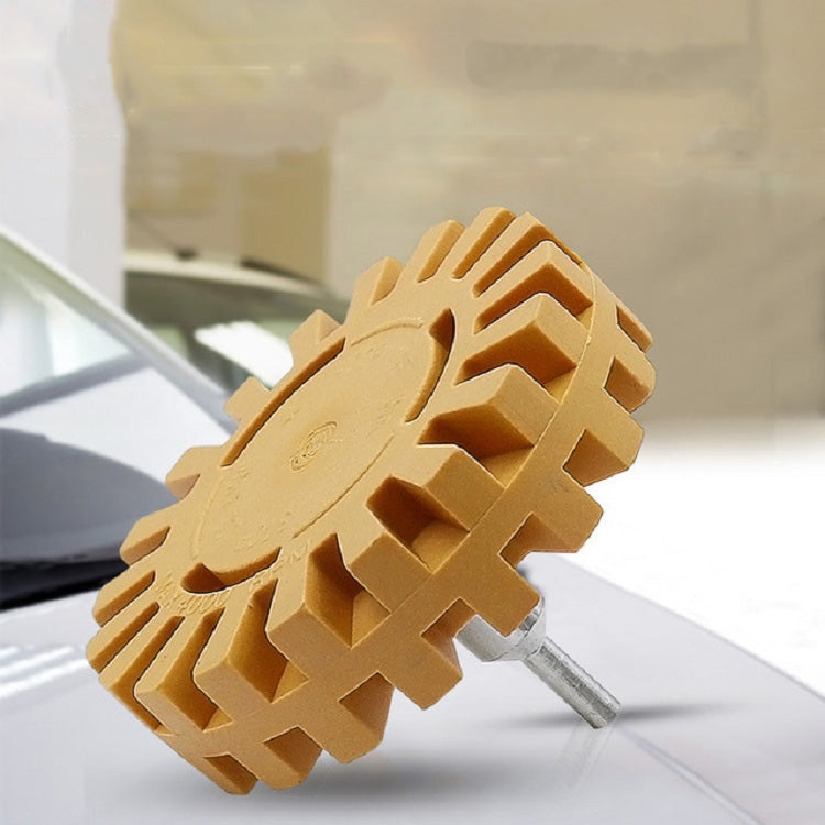 Rubber polishing removal wheel on metal spindle, yellow-brown toothed disc