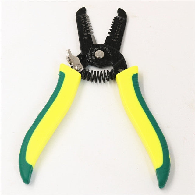 Cable stripper with black multi-tool head and yellow-green insulated grips
