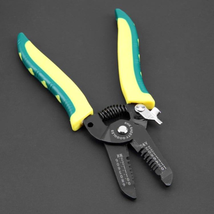 Cable stripping pliers with black head and yellow-green handles on dark background