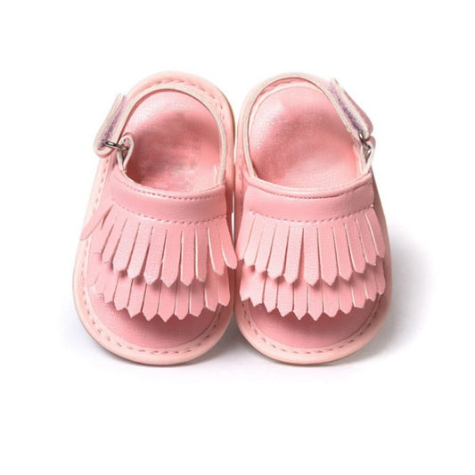 Pink fringed baby sandals with buckle-style ankle strap and open toe