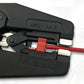 Close-up of AWG 32-7 marking on black self-adjusting stripping pliers with red insert