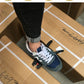 Self-adjusting stripping pliers near a sneaker on cardboard packing