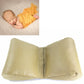 Light brown newborn positioning cushion with curved sides and center seam