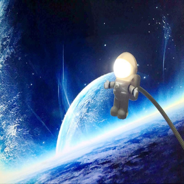 White astronaut LED desk lamp with glowing helmet and flexible cable