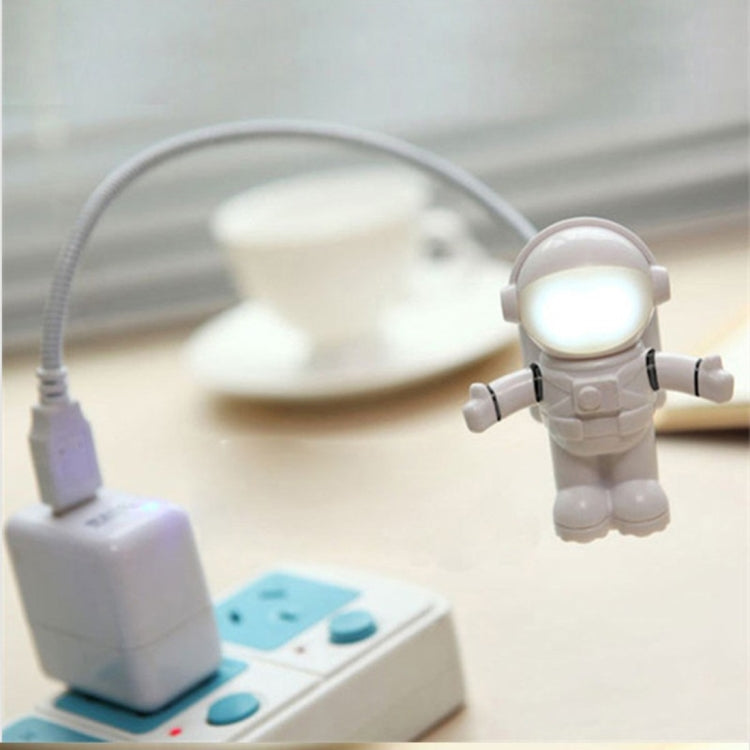 White astronaut USB LED desk light with lit helmet and USB cable