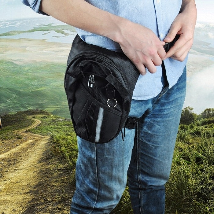 Black motocross waist leg bag worn at hip, with front zipper pocket and loop detail