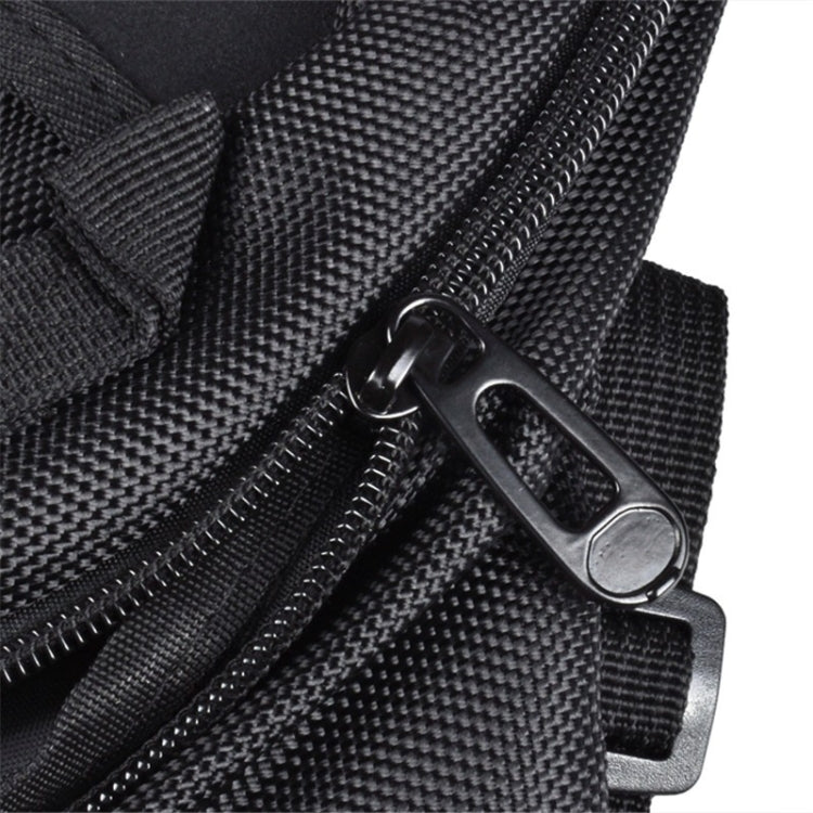 Close-up of black motocross bag zipper and metal pull with strap tab